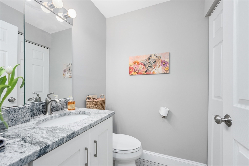 9 Park Hull Ma, Unit 505 Hull, MA 02045 - Photo 16 of 25 a bathroom with a granite countertop sink a toilet and a mirror
