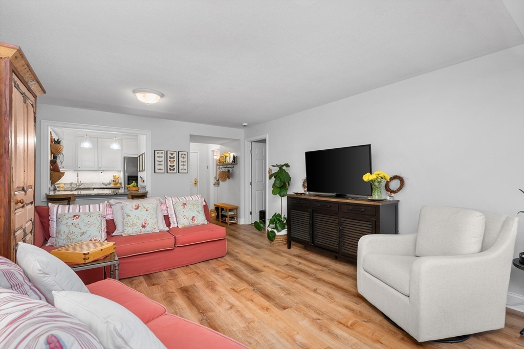 9 Park Hull Ma, Unit 505 Hull, MA 02045 - Photo 8 of 25 a living room with furniture and a flat screen tv
