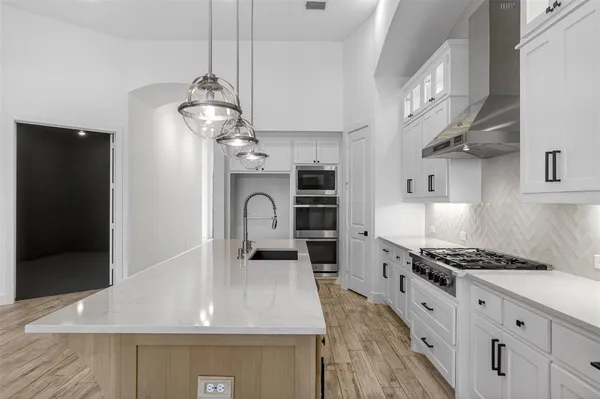 a kitchen with stainless steel appliances granite countertop a stove and a sink