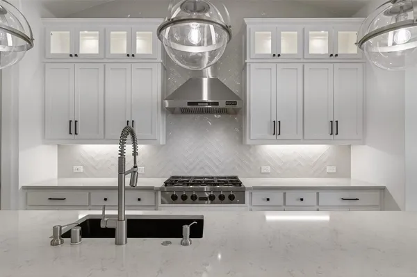 a view of a kitchen with a sink a kitchen microwave and cabinets