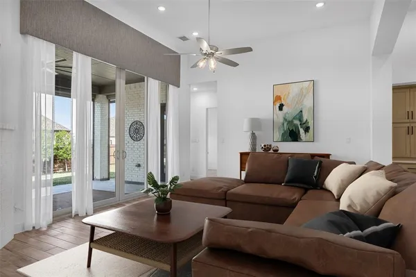 a view of a hallway with a ceiling fan