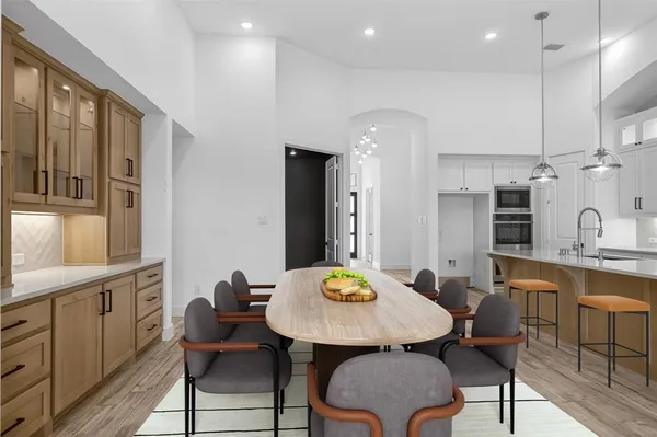 a large kitchen with stainless steel appliances kitchen island a large counter top and a wooden floors