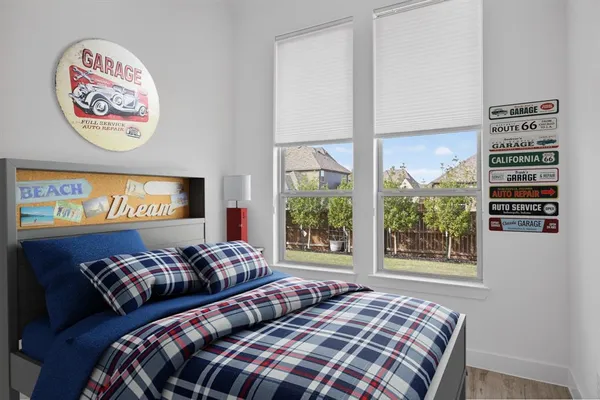 a bedroom with a bed and a dresser in it