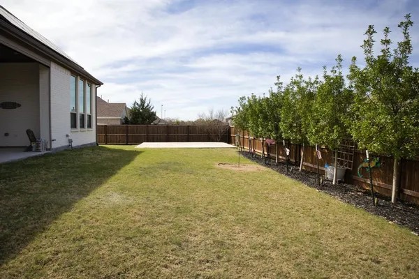 a view of a chairs and table in backyard