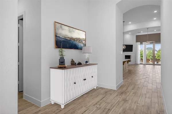 a large kitchen with stainless steel appliances a large counter top a stove a sink and a refrigerator