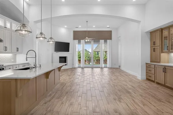a kitchen with kitchen island granite countertop a sink cabinets and stainless steel appliances