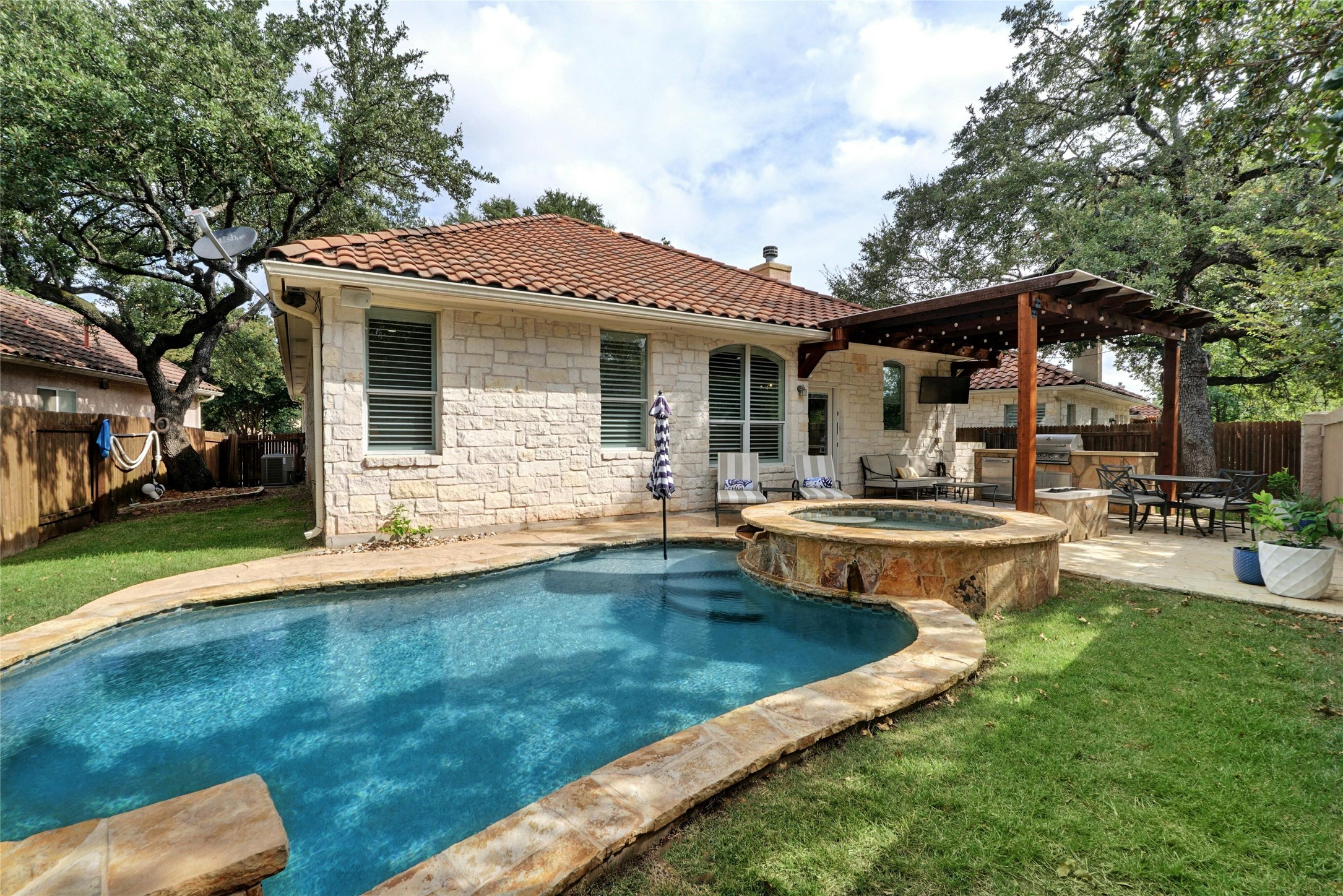 a view of a house with swimming pool and a yard