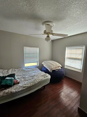a bedroom with bed and window