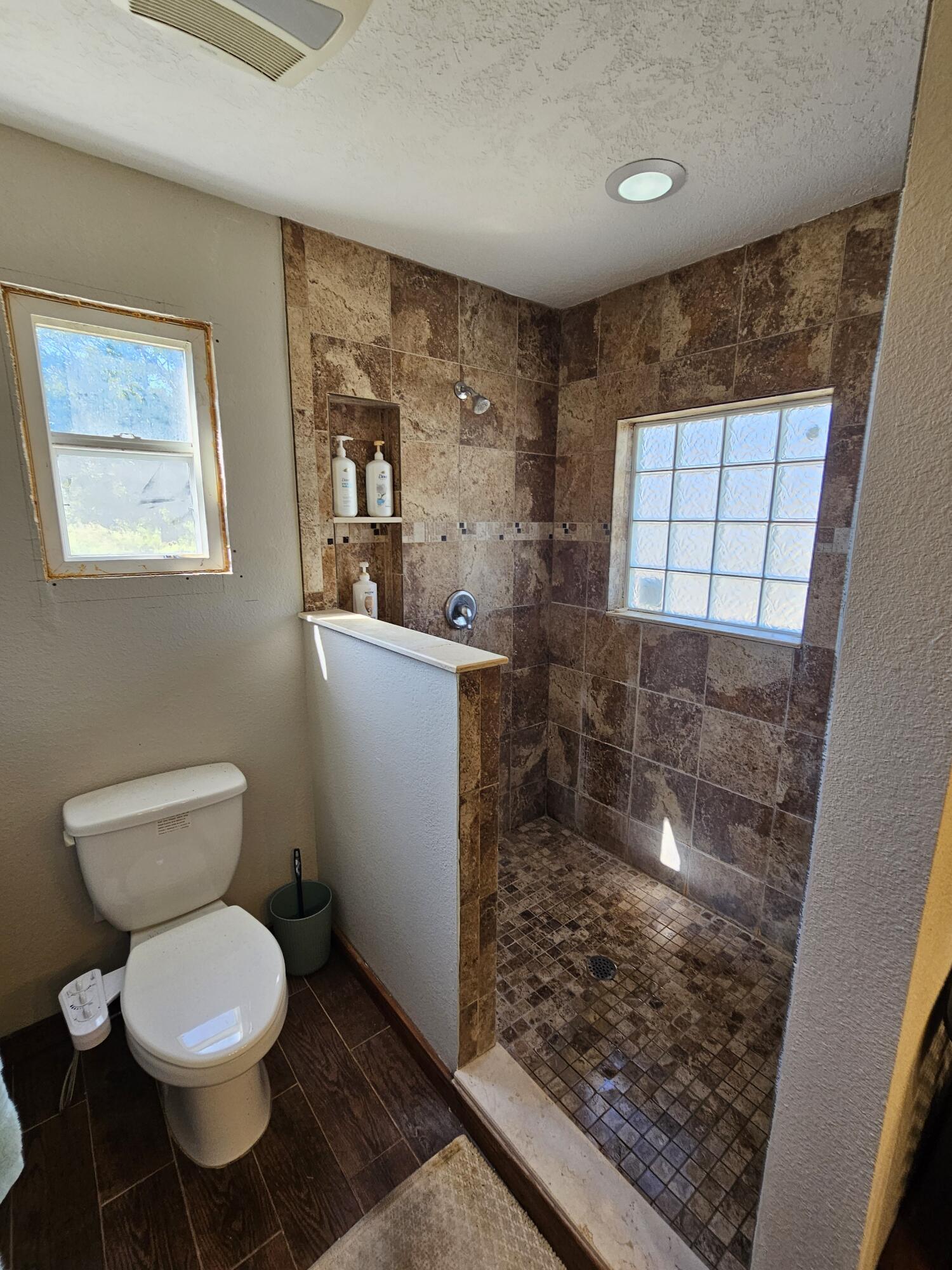 4900 Northwest 160th Street Okeechobee, FL 34972 - Photo 17 of 23 a bathroom with a toilet and a shower