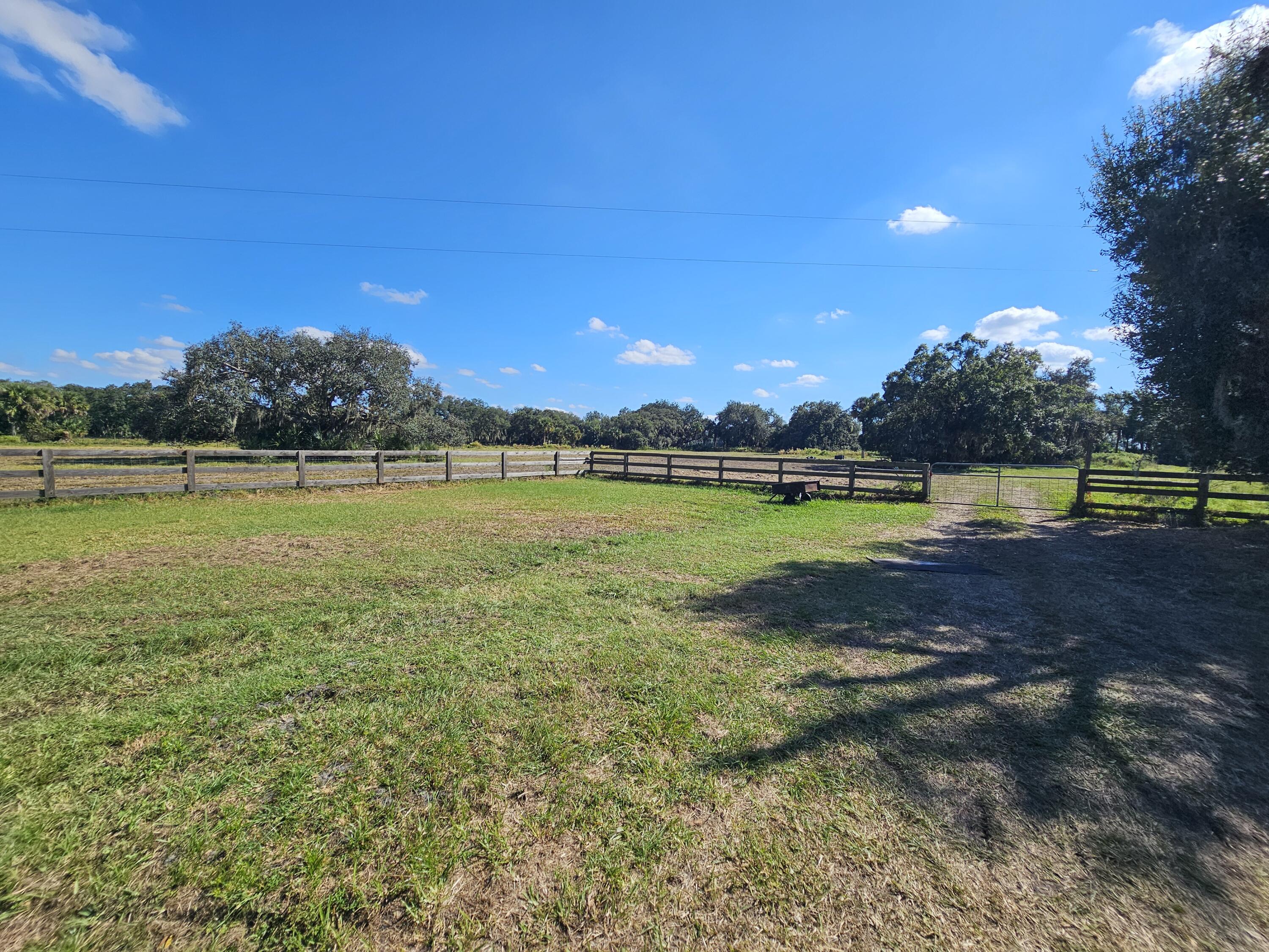 4900 Northwest 160th Street Okeechobee, FL 34972 - Photo 19 of 23 a view of a swimming pool with an ocean and trees in the background