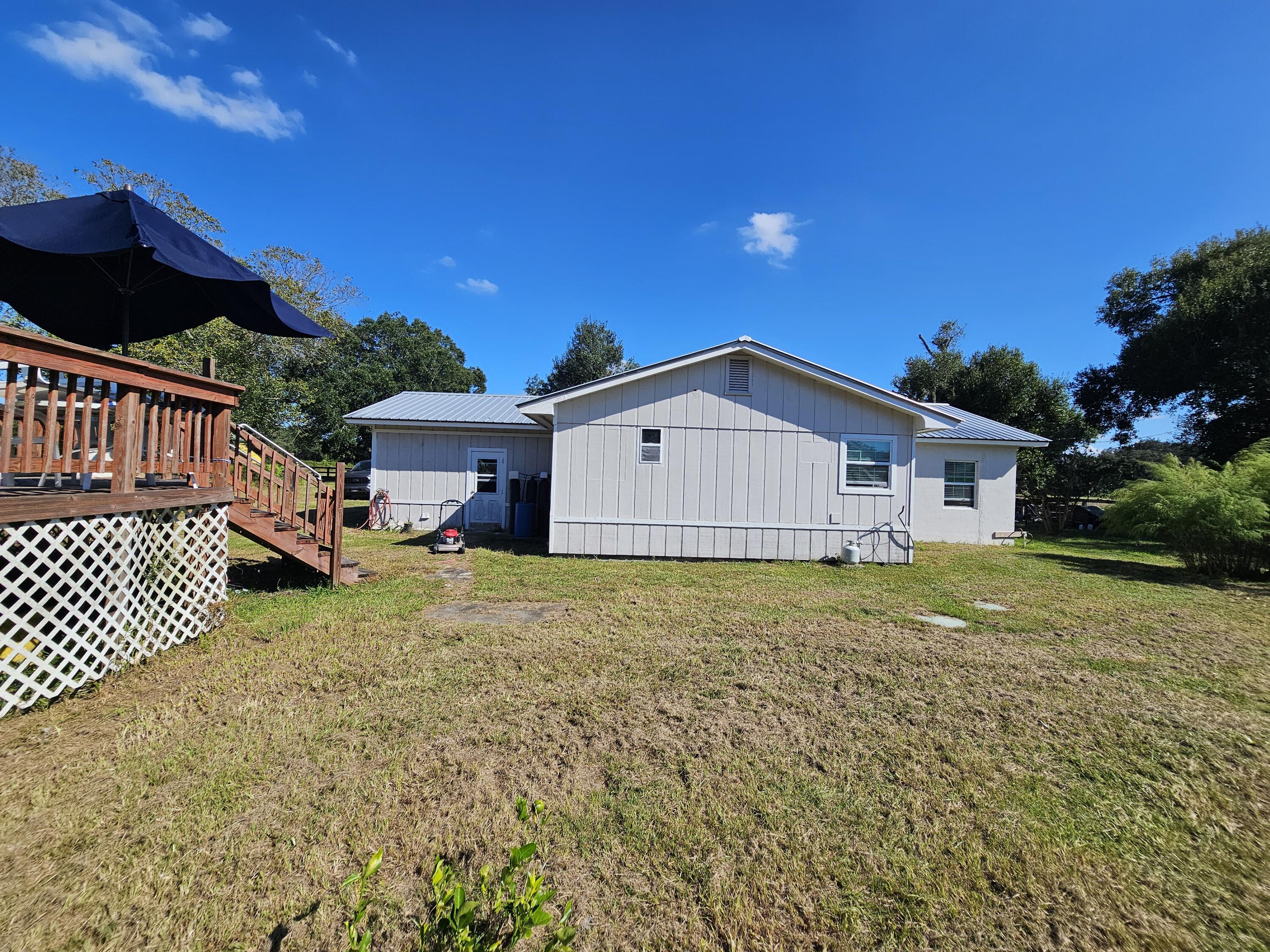4900 Northwest 160th Street Okeechobee, FL 34972 - Photo 21 of 23 a view of a house with a yard