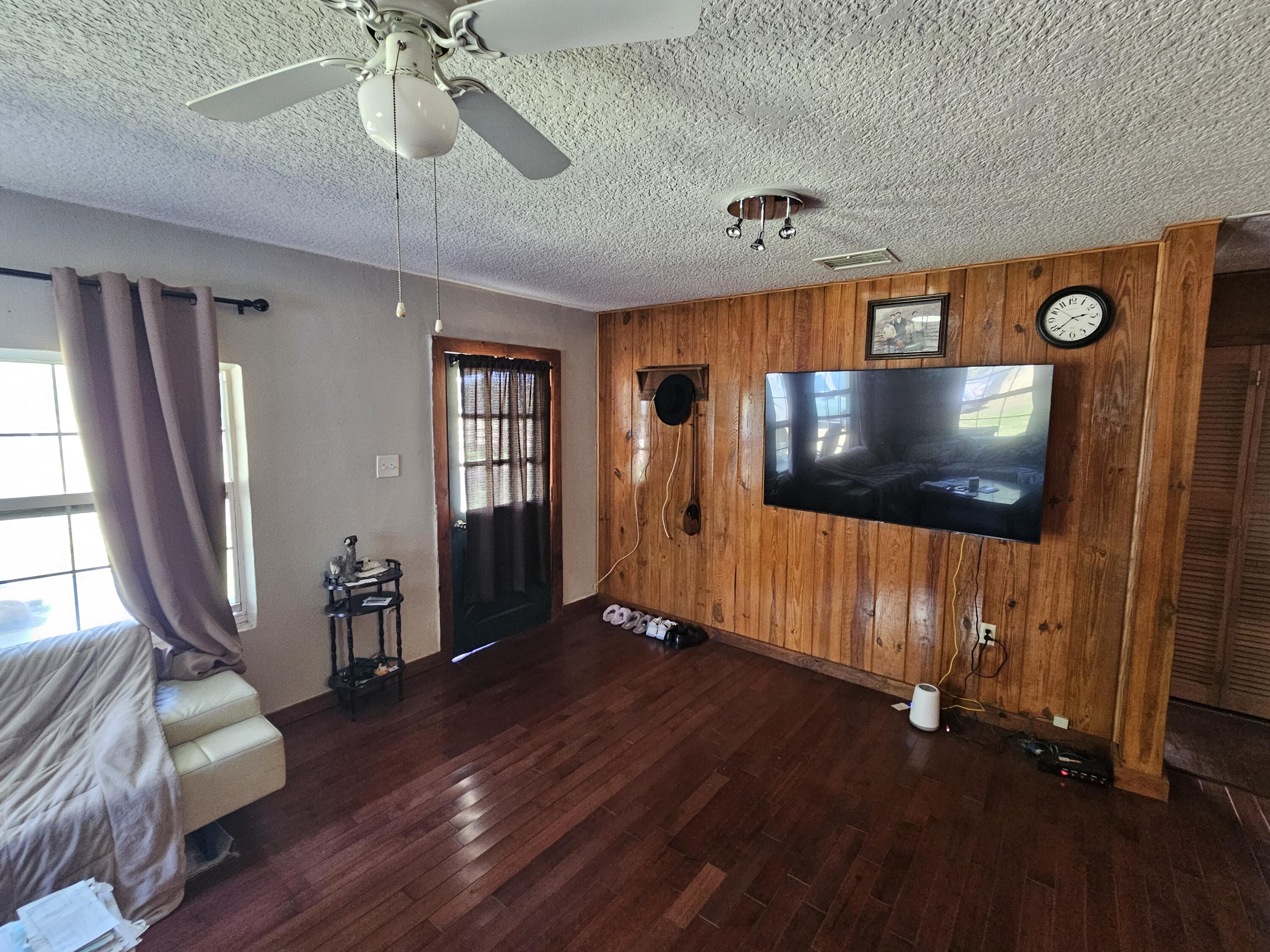 4900 Northwest 160th Street Okeechobee, FL 34972 - Photo 7 of 23 a living room with furniture and a flat screen tv