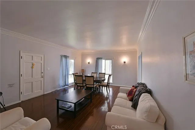 a living room with furniture a dining table and chairs