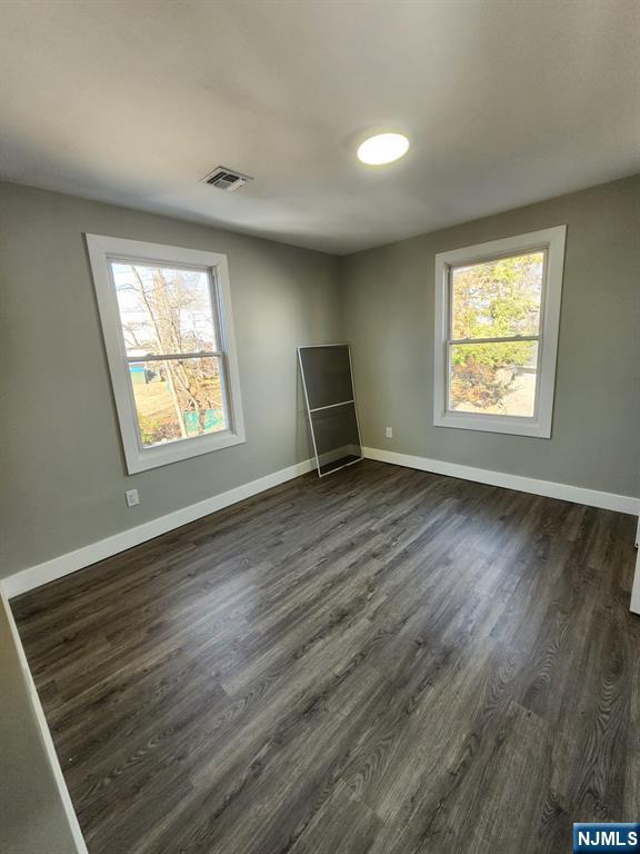93 Hughes Street, Unit 4 Maplewood, NJ 07040 - Photo 11 of 20 a view of an empty room with wooden floor and a window