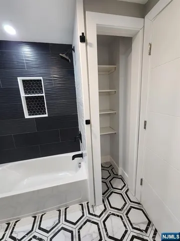 a bathroom with a bathtub and a shower