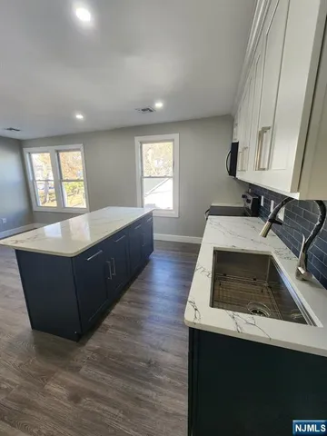 a kitchen with a sink and a stove top oven