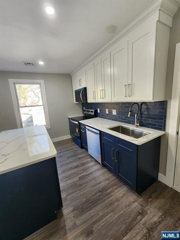93 Hughes Street, Unit 4 Maplewood, NJ 07040 - Photo 6 of 20 a kitchen with a sink a stove and cabinets