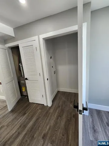 an empty room with wooden floor and a ceiling fan