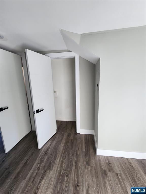 93 Hughes Street, Unit 4 Maplewood, NJ 07040 - Photo 9 of 20 an empty room with wooden floor and white doors