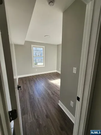 wooden floor in an empty room with a mirror