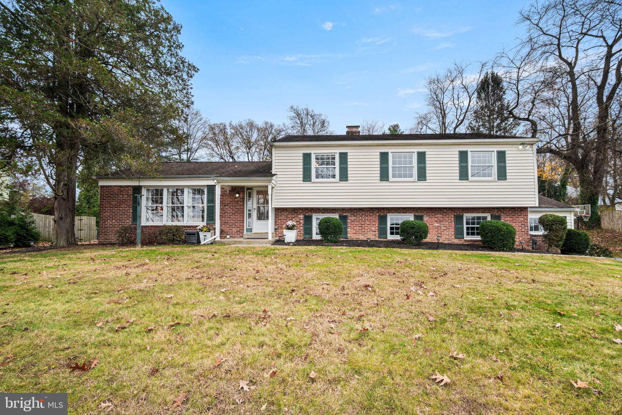 309 Saybrook Road Villanova, PA 19085 - Photo 1 of 47 a front view of a house with a garden and trees
