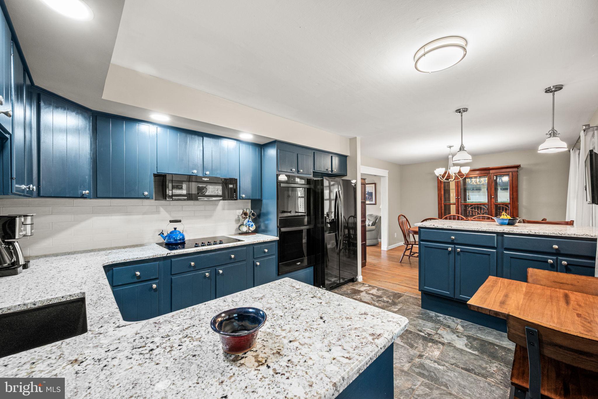309 Saybrook Road Villanova, PA 19085 - Photo 12 of 47 a kitchen with stainless steel appliances kitchen island granite countertop a refrigerator stove sink and cabinets