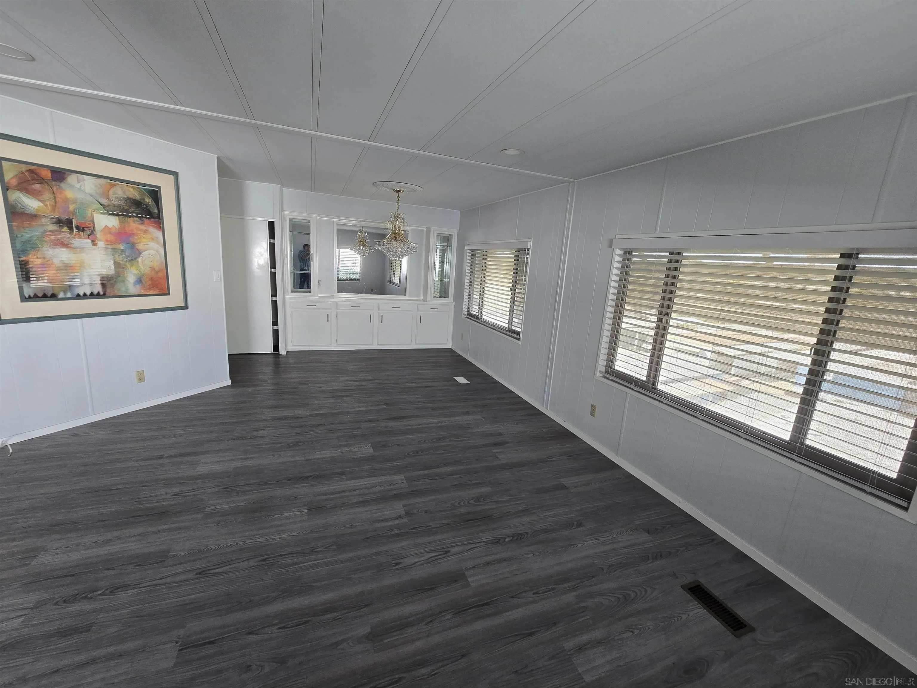 1815 Sweetwater Road, Unit SPC 120 Spring Valley, CA 91977 - Photo 3 of 49 a view of an empty room with wooden floor and a window