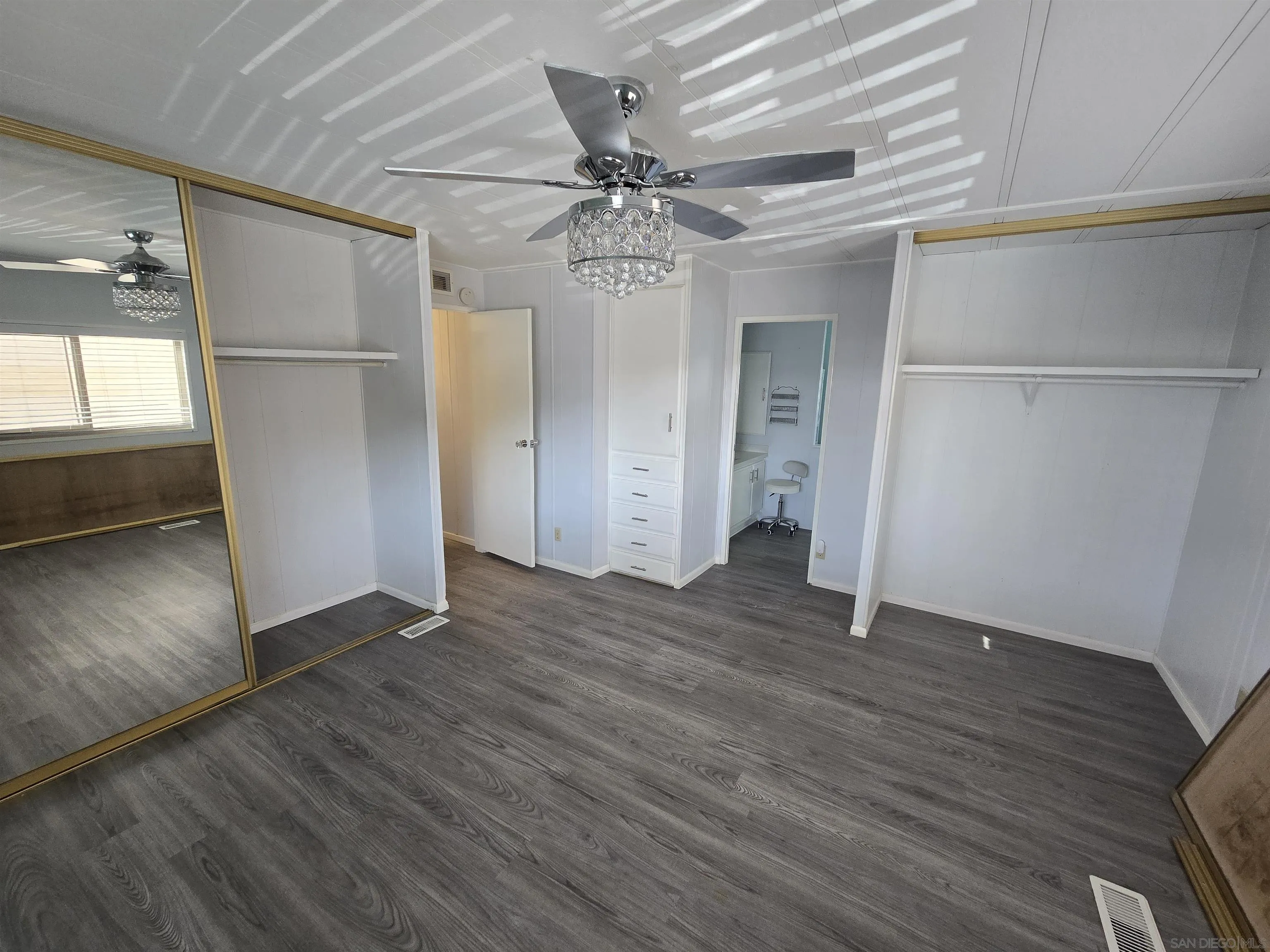1815 Sweetwater Road, Unit SPC 120 Spring Valley, CA 91977 - Photo 42 of 49 a view of an empty room with wooden floor and a window