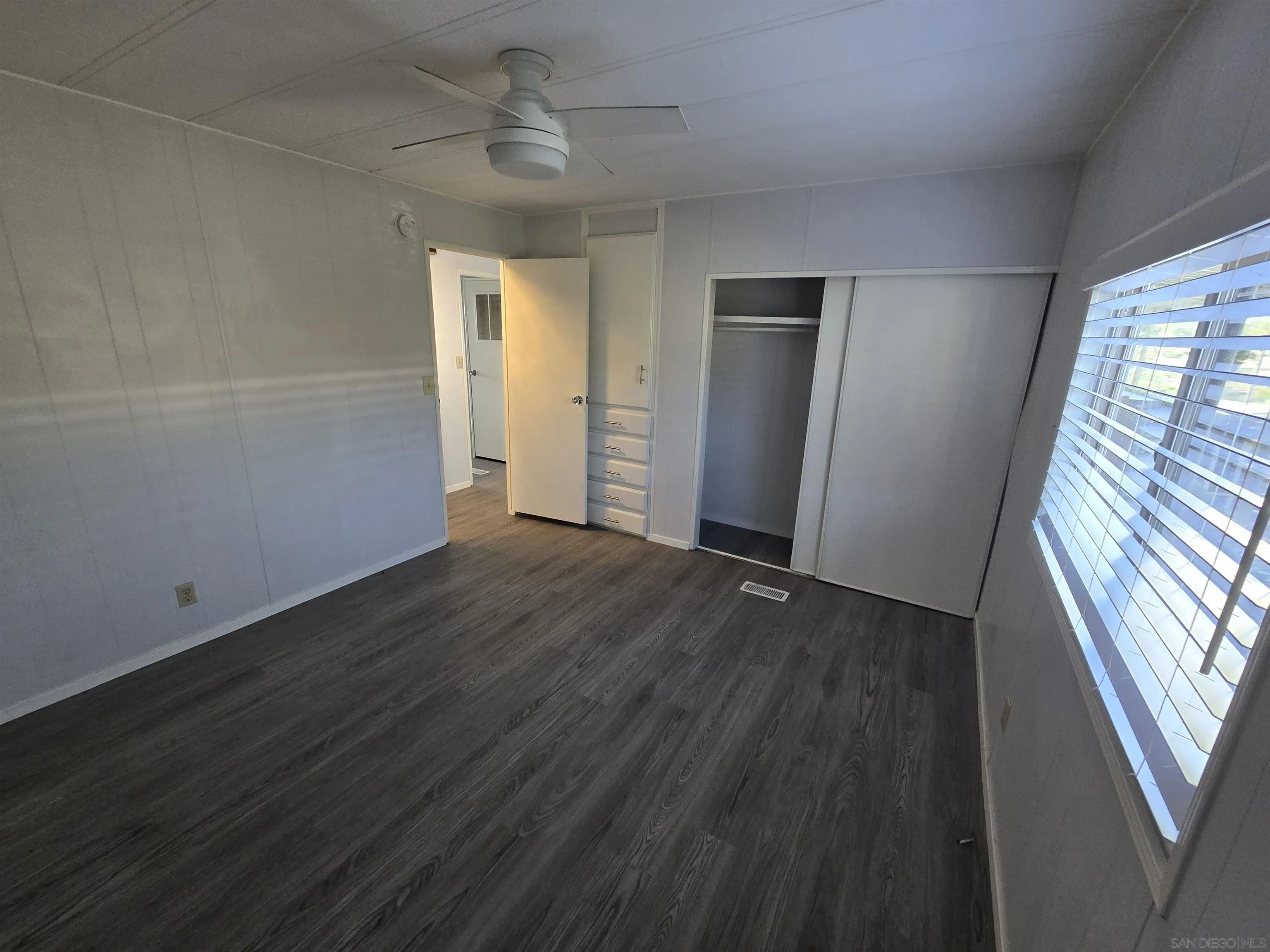 1815 Sweetwater Road, Unit SPC 120 Spring Valley, CA 91977 - Photo 44 of 49 a view of an empty room with wooden floor and a window