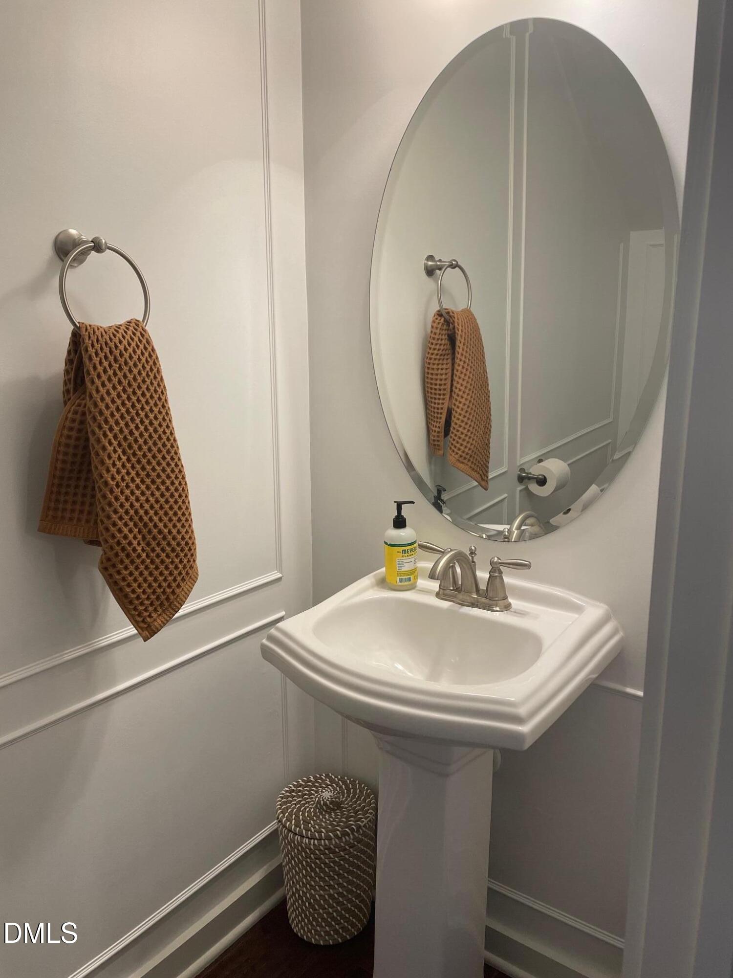 7802 Allscott Way Raleigh, NC 27612 - Photo 11 of 25 a bathroom with a sink and a mirror