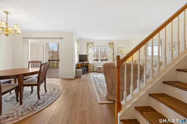 a view of a livingroom with furniture wooden floor and staircase