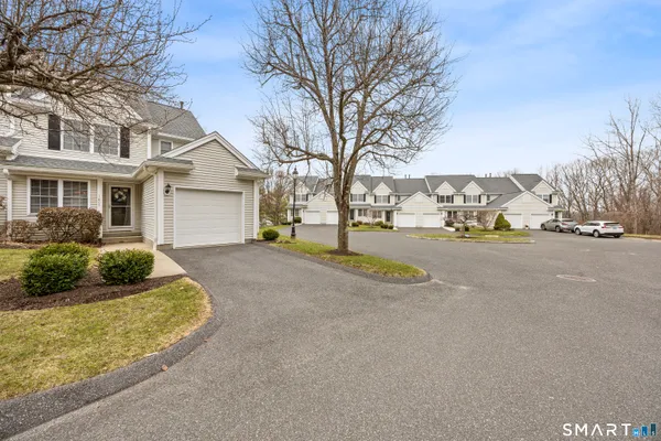 a view of a house with a yard and garage