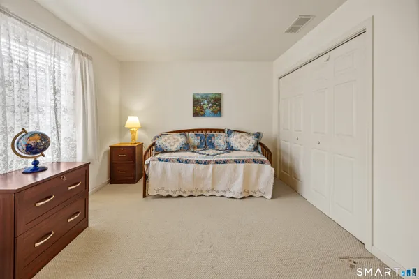 a bedroom with a bed and window