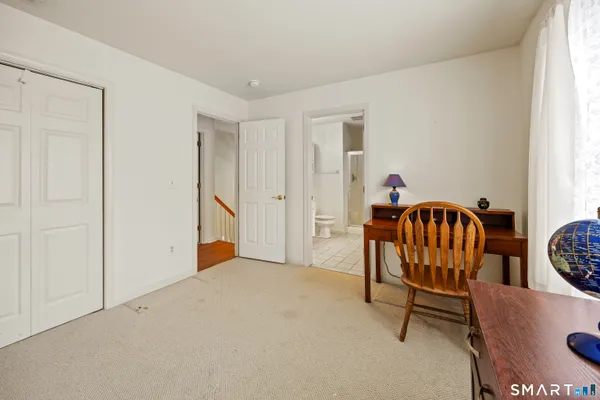 a bedroom with furniture and window