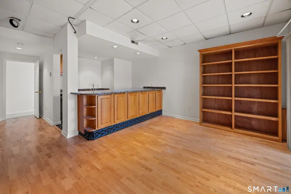 a view of an empty room with a fireplace and cabinet