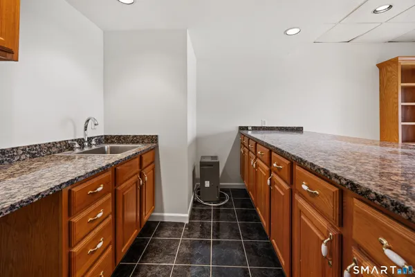 a kitchen with sink stove and cabinets
