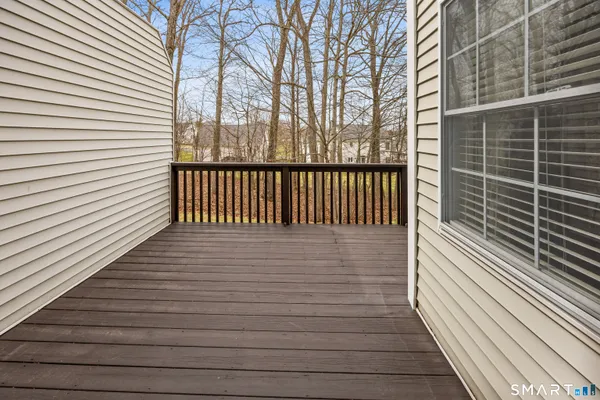 a view of a balcony with wooden floor
