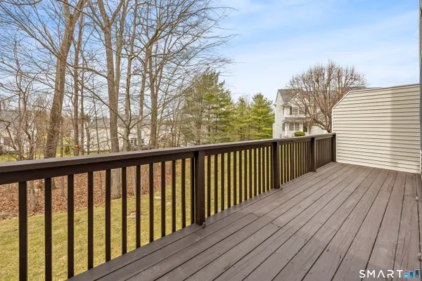 a balcony with wooden floor and fence