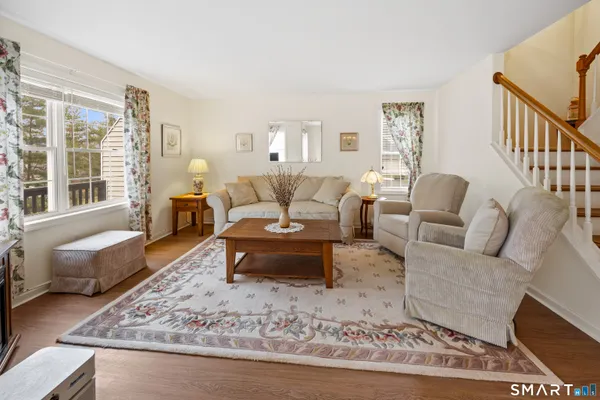 a living room with furniture and a rug