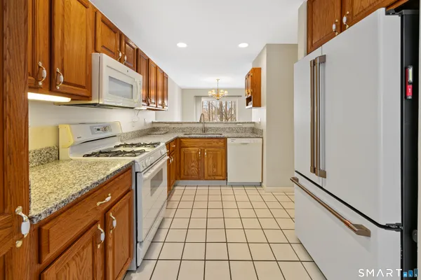 a kitchen with a sink a stove top oven and cabinetry