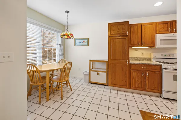 a kitchen that has a table and a stove in it