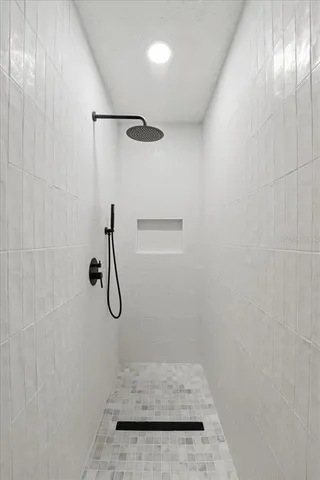 a bathroom with a glass shower door