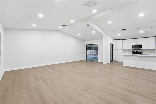 a view of a kitchen with a refrigerator and a sink