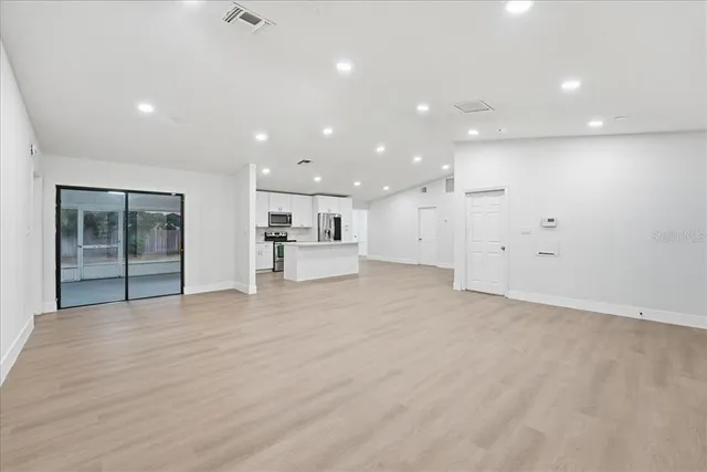 a view of a kitchen with a sink and a refrigerator