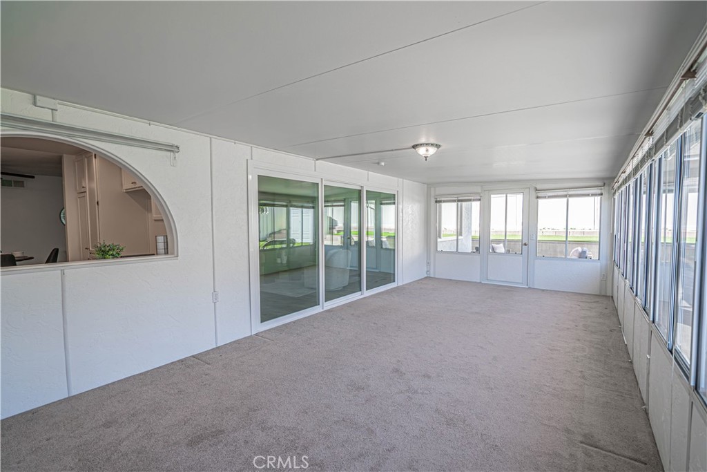 26478 Fairway Circle Newhall, CA 91321 - Photo 12 of 60 a view of an empty room with wooden floor and a window