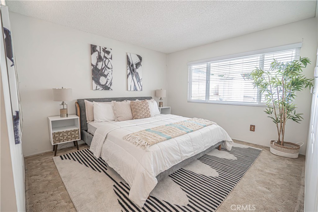 26478 Fairway Circle Newhall, CA 91321 - Photo 15 of 60 a bedroom with a large bed and a window