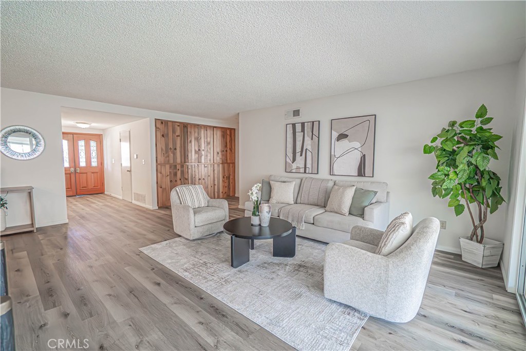 26478 Fairway Circle Newhall, CA 91321 - Photo 2 of 60 a living room with furniture and a potted plant