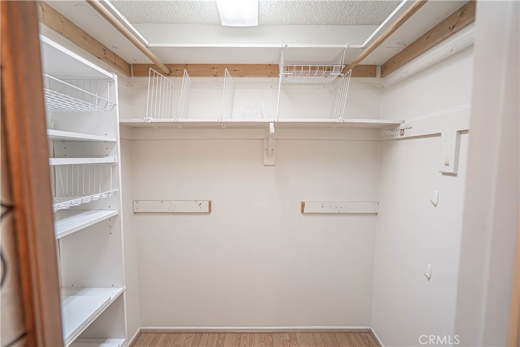 26478 Fairway Circle Newhall, CA 91321 - Photo 22 of 60 a view of walk in closet with empty racks