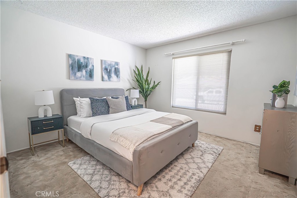 26478 Fairway Circle Newhall, CA 91321 - Photo 23 of 60 a bedroom with a large bed and a window