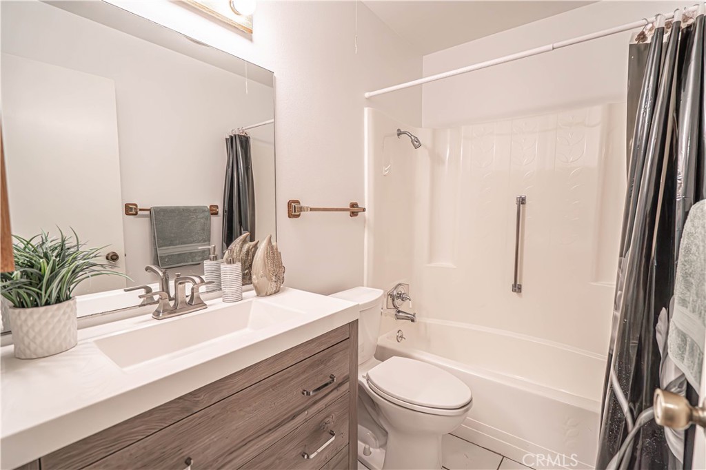 26478 Fairway Circle Newhall, CA 91321 - Photo 24 of 60 a bathroom with a sink a toilet a mirror and shower